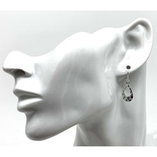 Dainty sterling silver teardrop earrings add elegance to a professional work look.
