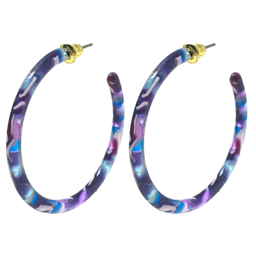A pair of large, statement resin hoop earrings with a beautiful purple and blue marbled design.